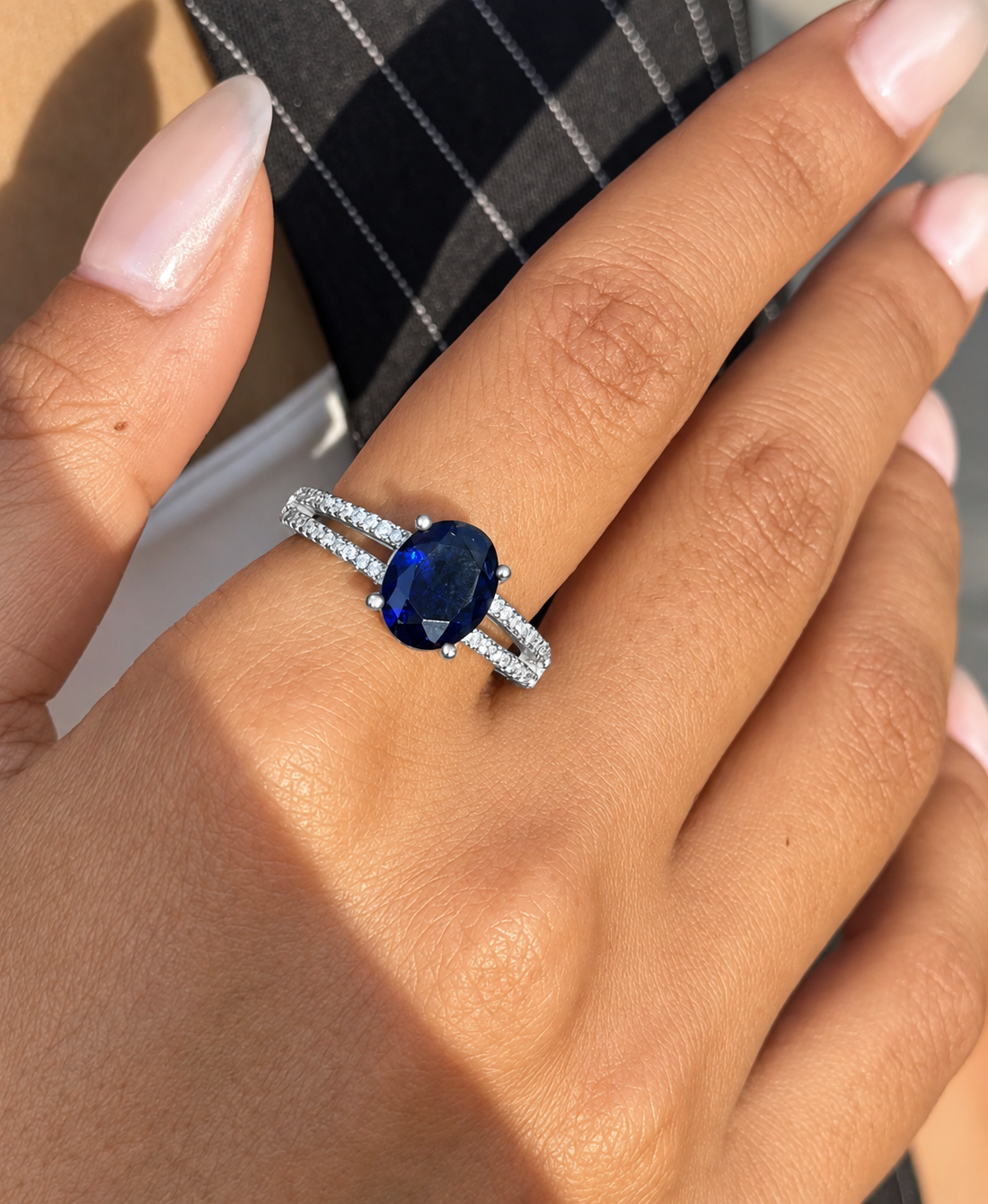 Woman wearing a royal-blue oval cubic zirconia silver ring
