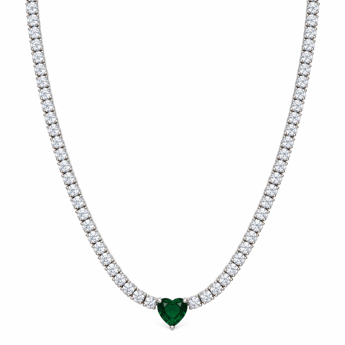 A tennis-style necklace with a heart-shaped green gemstone pendant, set in a silver-toned metal with a row of clear stones along the chain, shown against a plain white background.