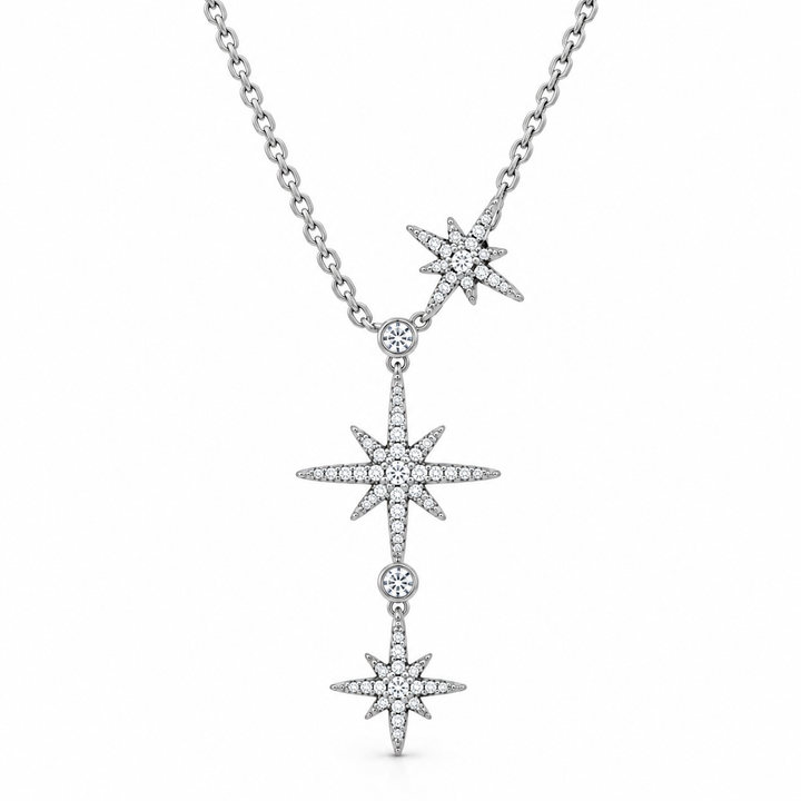 A silver-toned Y-necklace featuring three vertically aligned starburst pendants, each adorned with small clear stones, on a plain white background.